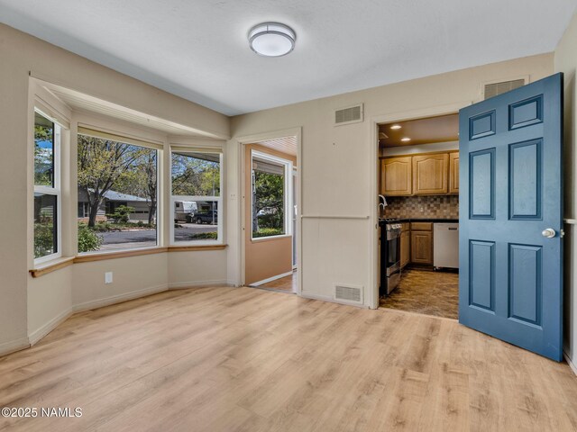 415 W Apache Rd, Flagstaff, AZ 86001 - unfurnished living room featuring healthy amount of natural light, light wood-style flooring, and baseboards