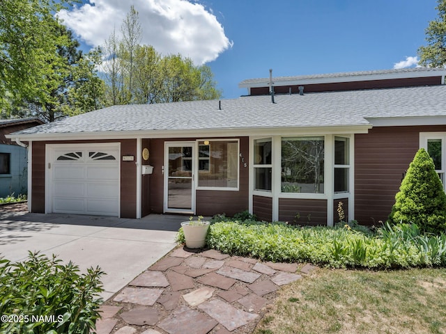 415 W Apache Rd, Flagstaff, AZ 86001 - single story home with concrete driveway, an attached garage, and a shingled roof