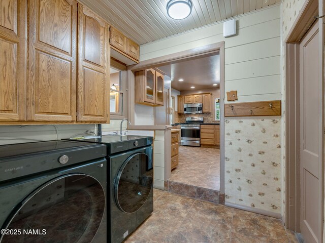 415 W Apache Rd, Flagstaff, AZ 86001 - washroom with washer and clothes dryer, cabinet space, and stone finish flooring