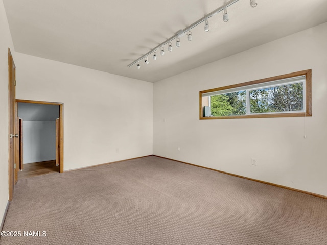 415 W Apache Rd, Flagstaff, AZ 86001 - carpeted empty room with track lighting and baseboards