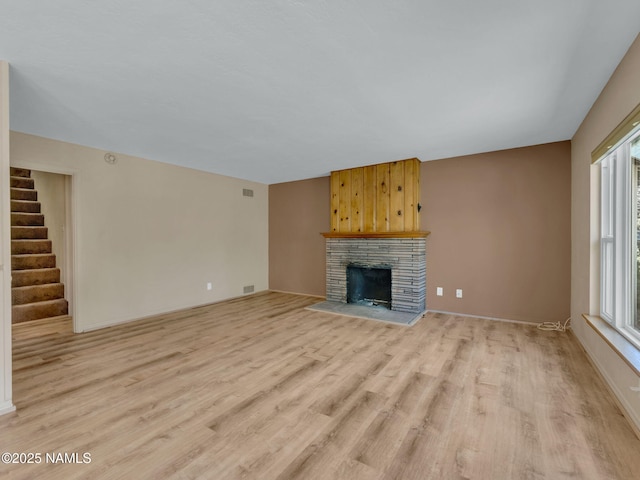 415 W Apache Rd, Flagstaff, AZ 86001 - unfurnished living room featuring light wood-style floors, healthy amount of natural light, and stairs
