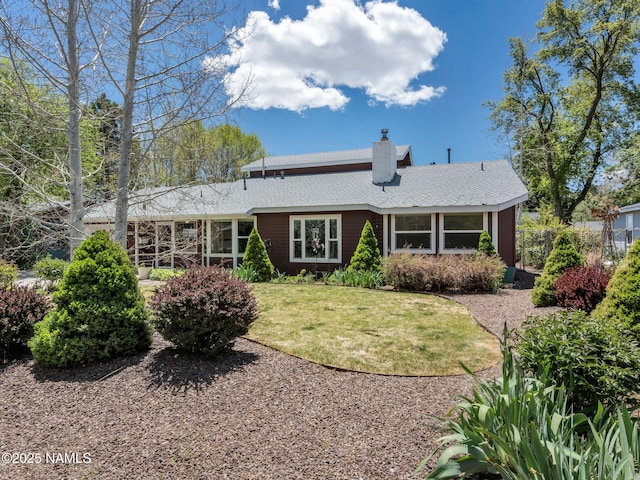 415 W Apache Rd, Flagstaff, AZ 86001 - back of house featuring a chimney, a yard, and a shingled roof