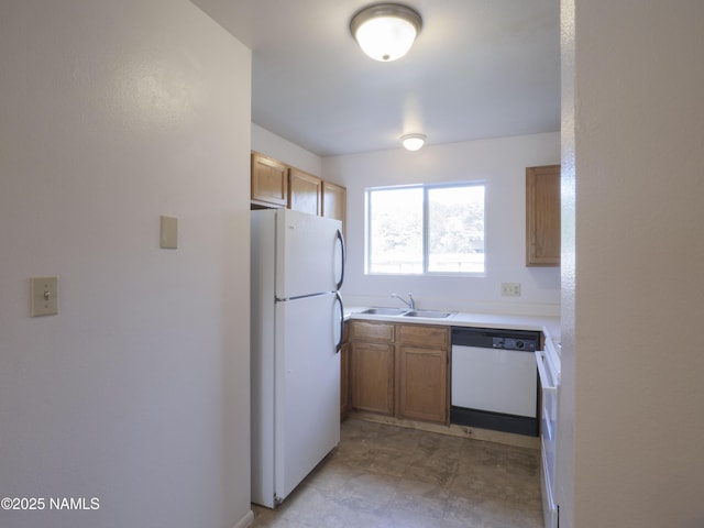 2401 N W St Unit 107, Flagstaff, AZ 86004 - kitchen with white appliances, light countertops, a sink, brown cabinets, and a textured wall