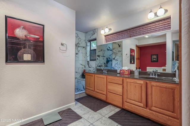 full bathroom featuring a marble finish shower, double vanity, and tile patterned flooring