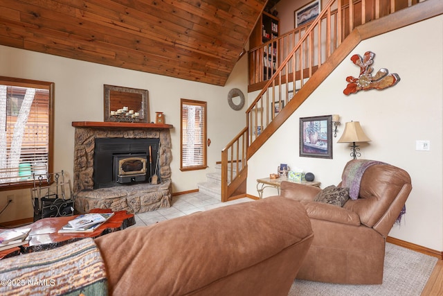 living area with stairs, baseboards, vaulted ceiling, wooden ceiling, and a wood stove