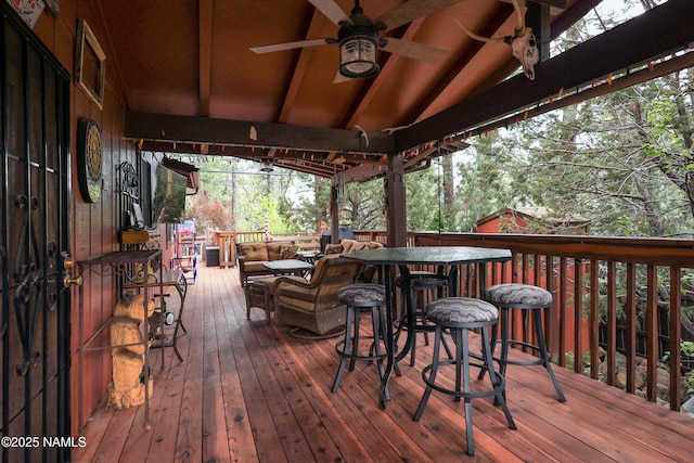 deck with a ceiling fan and an outdoor living space