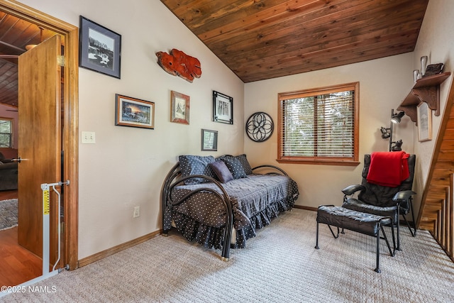 bedroom featuring lofted ceiling, carpet flooring, wood ceiling, and baseboards