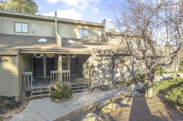 back of house featuring a deck