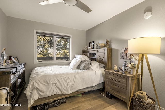 bedroom with ceiling fan and hardwood / wood-style flooring