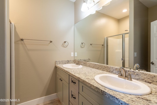 2553 W Cripple Creek Dr, Flagstaff, AZ 86001 - bathroom featuring double vanity, baseboards, a stall shower, and tile patterned flooring