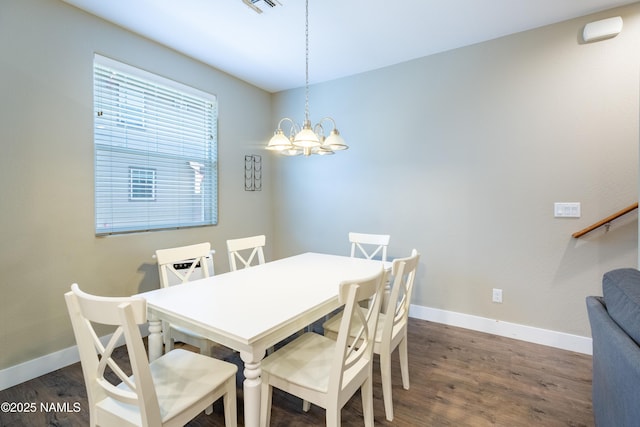 2553 W Cripple Creek Dr, Flagstaff, AZ 86001 - dining area with wood finished floors, baseboards, and a chandelier