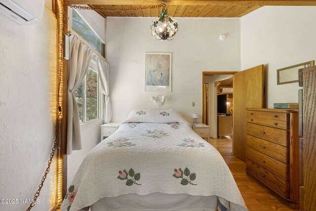 655 E Trout Creek Rd, Munds Park, AZ 86017 - bedroom featuring a wall unit AC, wood finished floors, and wood ceiling