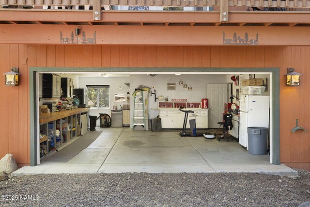 655 E Trout Creek Rd, Munds Park, AZ 86017 - garage featuring freestanding refrigerator and wood walls