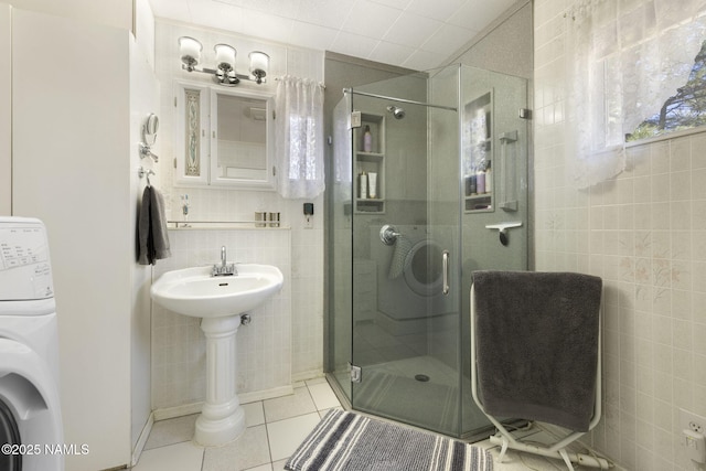 655 E Trout Creek Rd, Munds Park, AZ 86017 - bathroom featuring tile walls, a shower stall, tile patterned floors, washer / dryer, and decorative backsplash