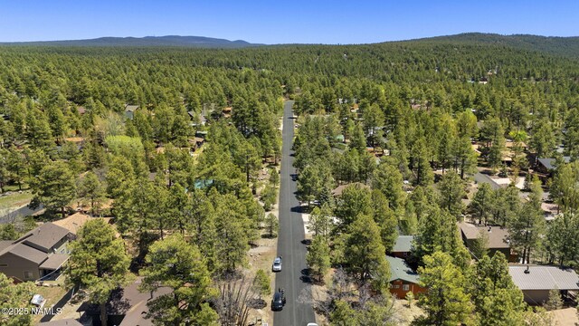 655 E Trout Creek Rd, Munds Park, AZ 86017 - aerial view of property and surrounding area featuring a heavily wooded area and a mountainous background