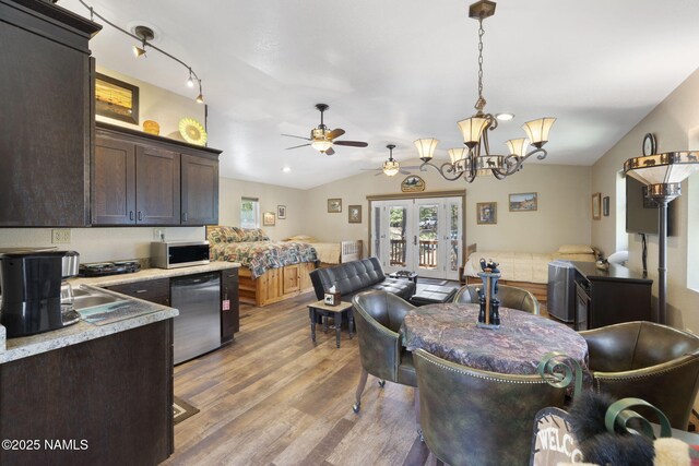 655 E Trout Creek Rd, Munds Park, AZ 86017 - dining room featuring light wood finished floors, ceiling fan, vaulted ceiling, and a chandelier
