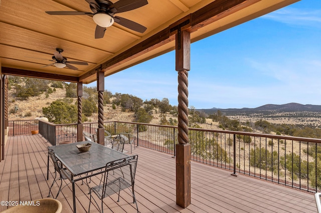 deck featuring a mountain view and ceiling fan