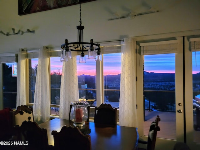 dining space with a mountain view and a chandelier