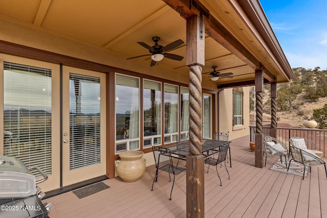 wooden deck featuring ceiling fan