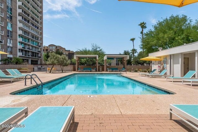 community pool featuring a patio and fence
