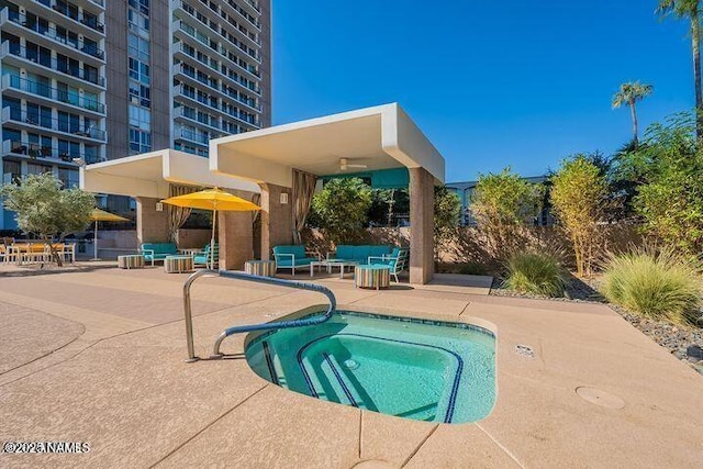 view of swimming pool with a patio and a hot tub
