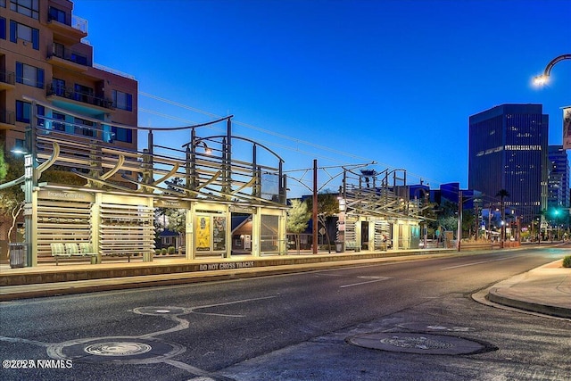 view of street featuring street lights, sidewalks, and curbs