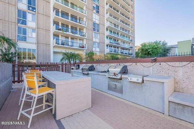 view of patio / terrace with grilling area, exterior kitchen, and outdoor wet bar