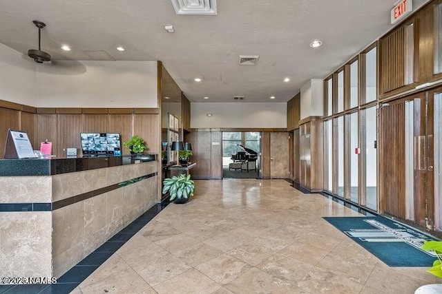 reception area featuring visible vents and ceiling fan