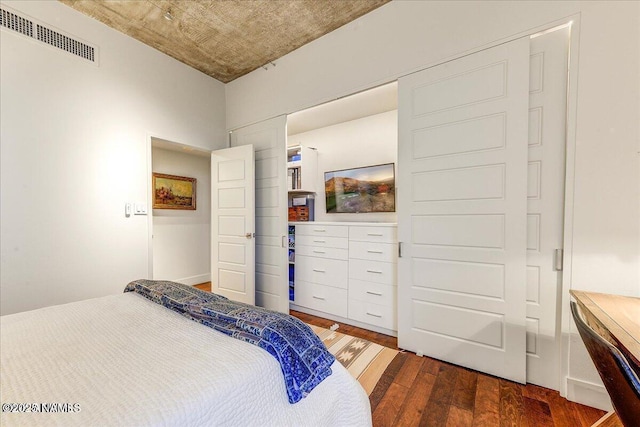 bedroom with wood finished floors and visible vents