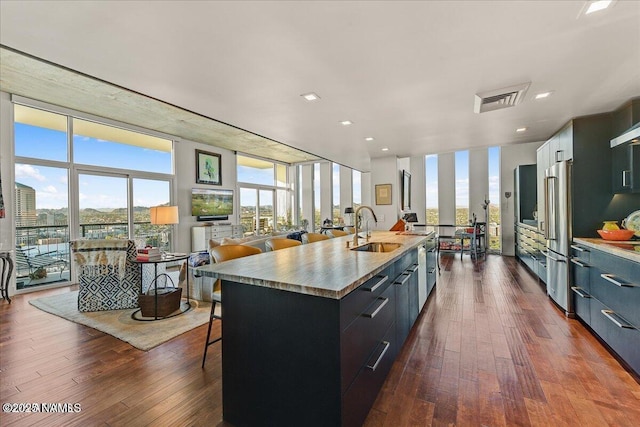 kitchen featuring a wall of windows, a sink, and modern cabinets
