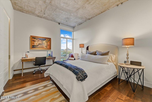 bedroom featuring baseboards and hardwood / wood-style floors
