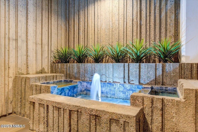 view of swimming pool featuring an in ground hot tub