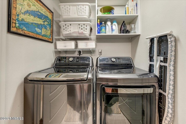 clothes washing area with independent washer and dryer and laundry area