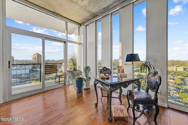 sunroom / solarium with wood-type flooring and expansive windows
