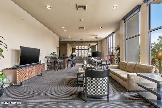 living room featuring carpet, recessed lighting, and visible vents