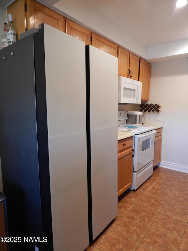1000 N Beaver St Unit 116, Flagstaff, AZ 86001 - kitchen with white appliances, light countertops, light tile patterned floors, and recessed lighting