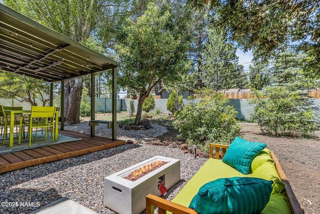 view of patio with a deck and an outdoor fire pit