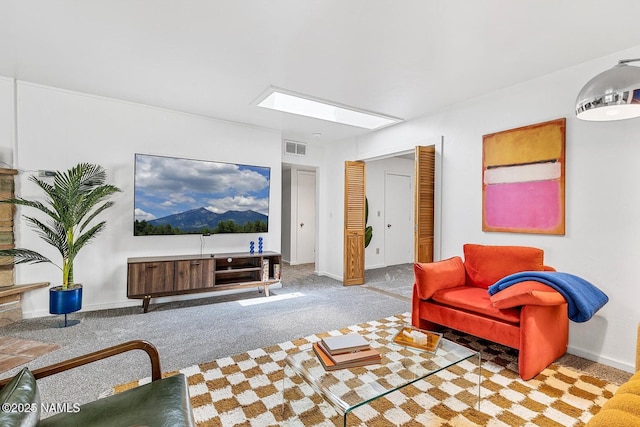 carpeted living room with a skylight