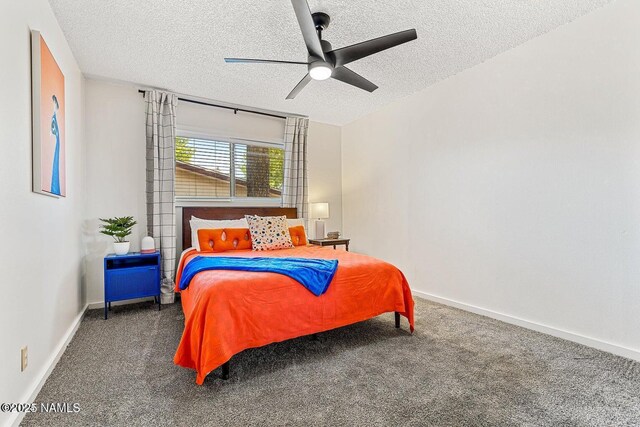 bedroom featuring ceiling fan, dark carpet, and a textured ceiling