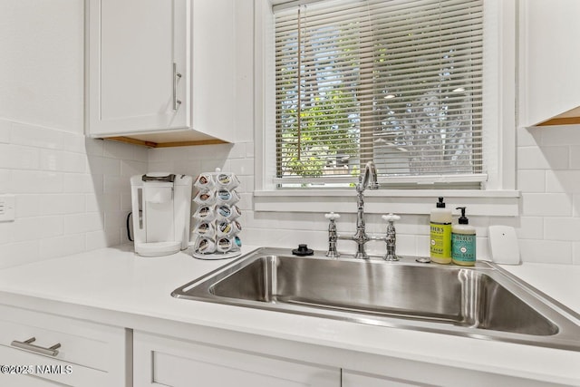 kitchen with sink, decorative backsplash, and white cabinets