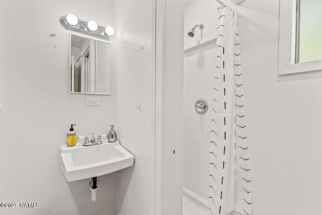 bathroom with sink and curtained shower