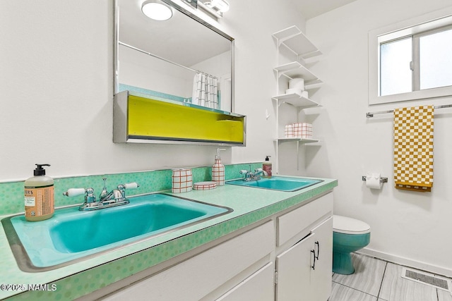 bathroom with vanity, curtained shower, and toilet