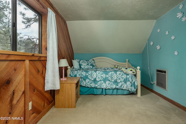 carpeted bedroom featuring baseboards, vaulted ceiling, and a textured ceiling