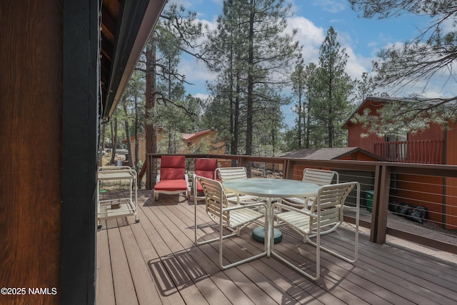 wooden deck with outdoor dining space