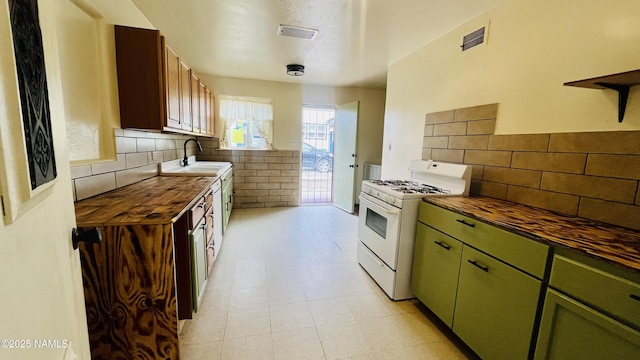 401 N Kinsley Ave, Winslow, AZ 86047 - kitchen with gas range gas stove, wood counters, a sink, and green cabinetry