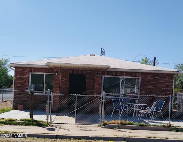 401 N Kinsley Ave, Winslow, AZ 86047 - view of front of property with brick siding and a gate