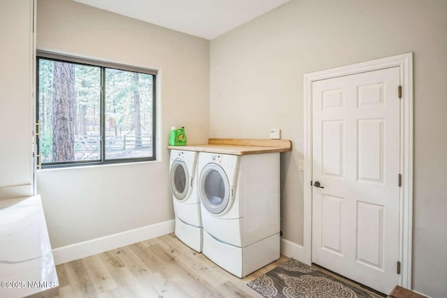 3605 N Langdale Trl, Flagstaff, AZ 86001 - laundry room featuring washer and clothes dryer, light wood-type flooring, and baseboards