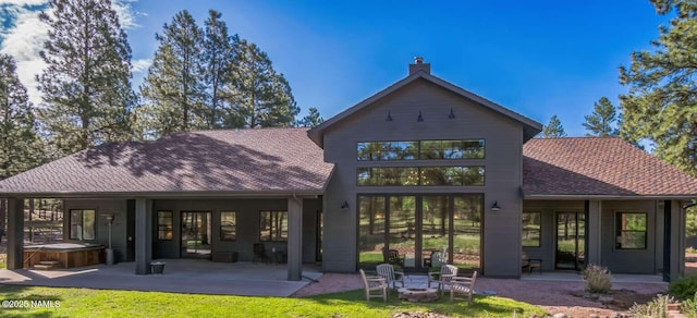 3605 N Langdale Trl, Flagstaff, AZ 86001 - rear view of property with a hot tub, a patio area, an outdoor fire pit, and roof with shingles