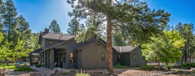 3605 N Langdale Trl, Flagstaff, AZ 86001 - view of side of property featuring a chimney and stucco siding