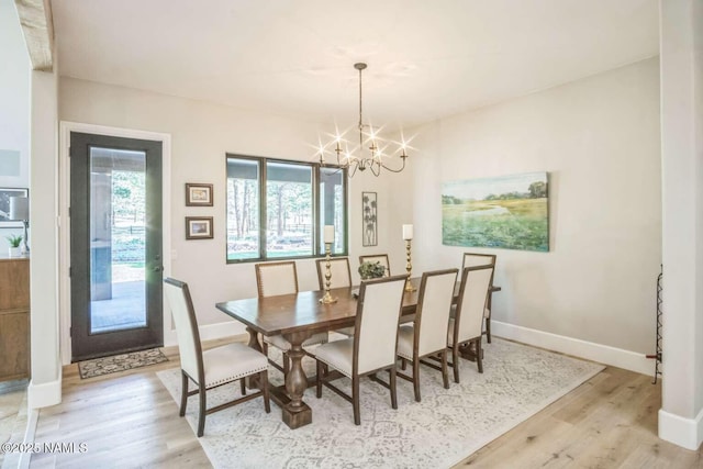 3605 N Langdale Trl, Flagstaff, AZ 86001 - dining area with a chandelier, light wood-style flooring, and baseboards